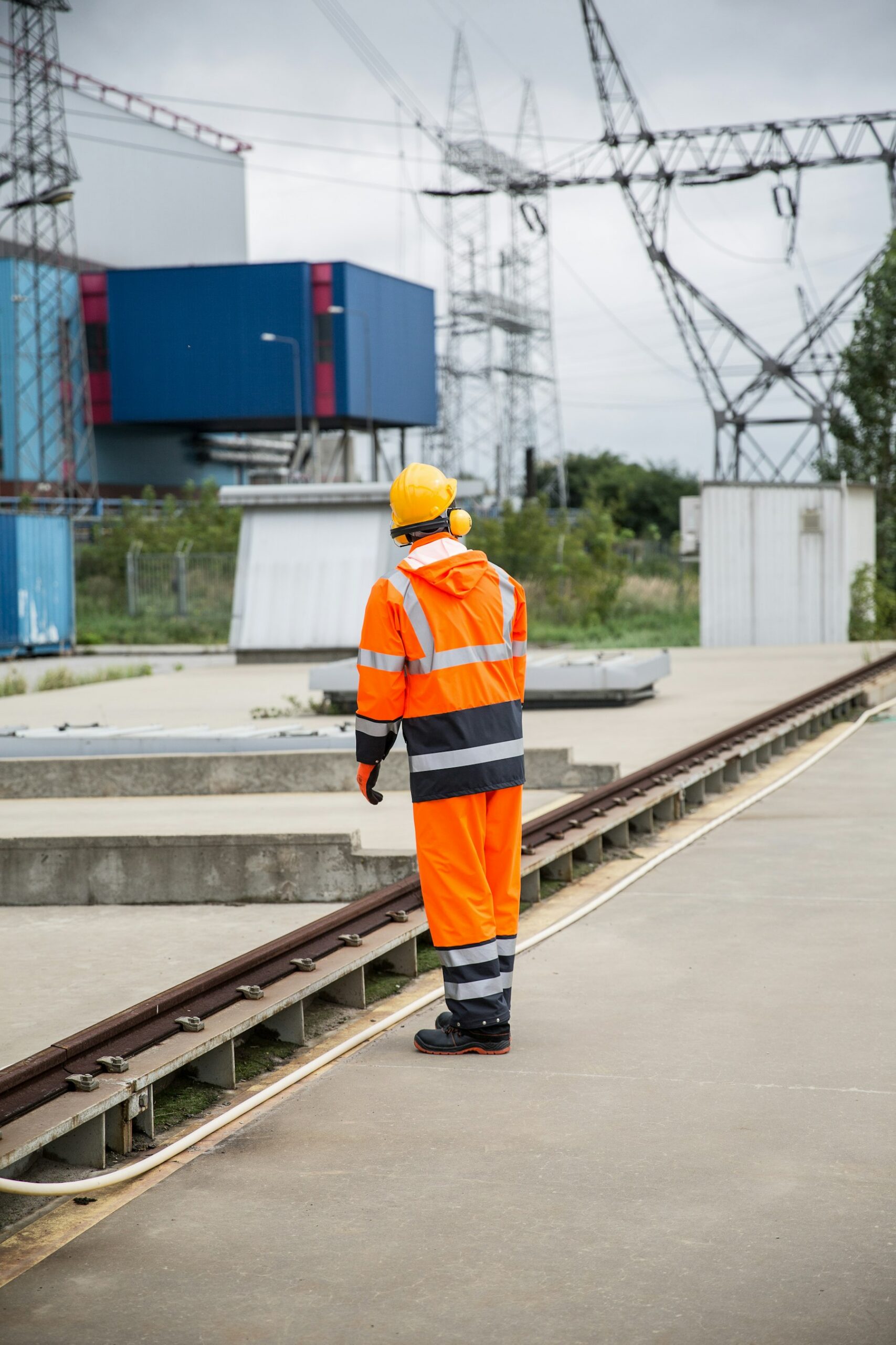 A worker in high visibility clothing alone on an industrial site