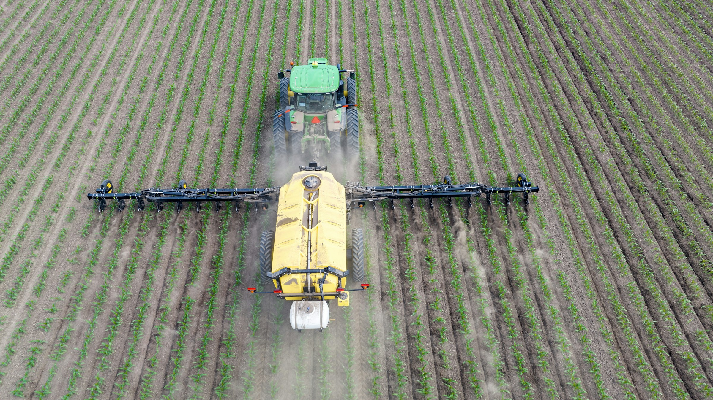 A machine working across a crop field.