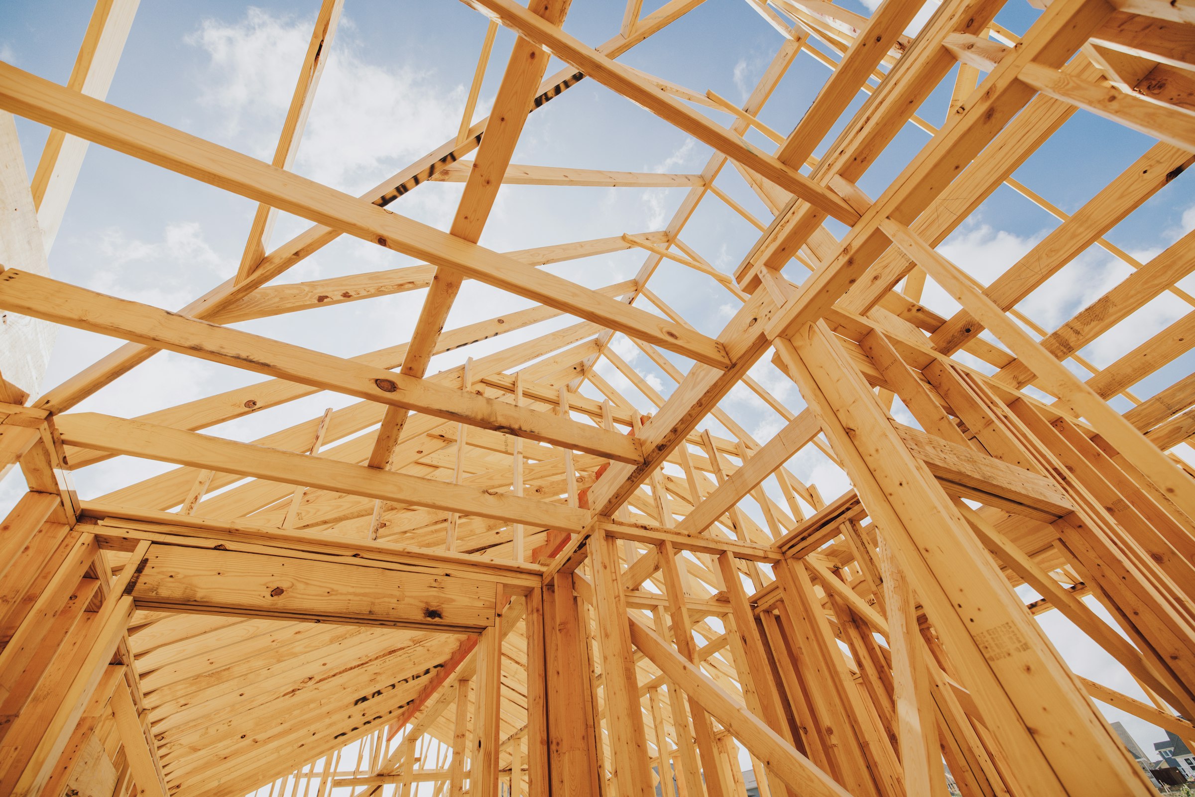 A timber building frame under construction.