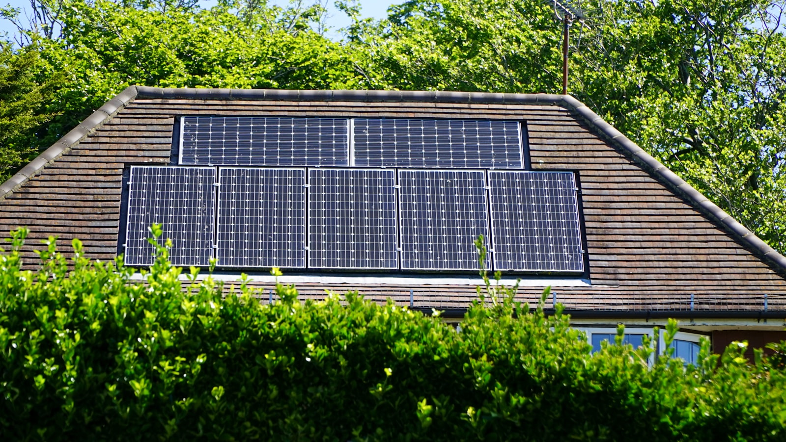 Solar panels covering the roof and upper wall of a commercial building.