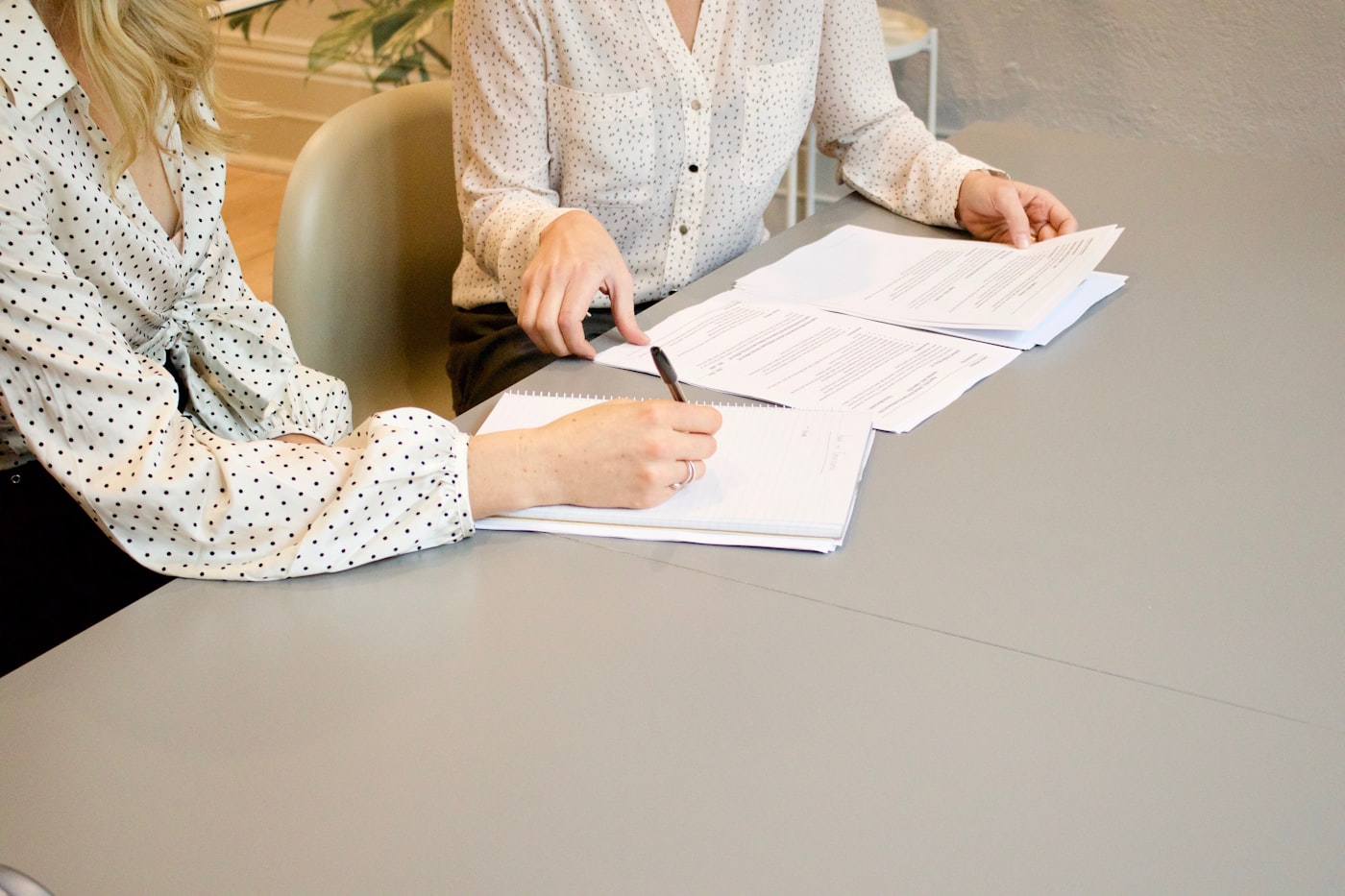 Two people going through documents at a desk
