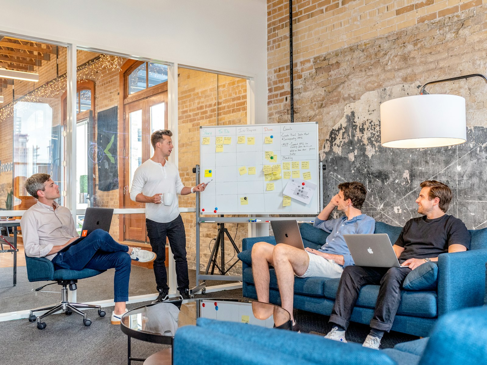 A working team with laptops around a whiteboard